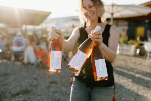 Jayme of The Storm Cellar holding rose wine