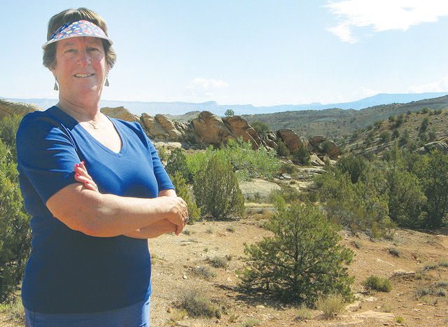 Barbara Bowman takes in the views from the Devils Kitchen picnic area in the Colorado National Monument near Grand Junction. It’s just one of the attractions she’s promoted during a nearly 30-year career in Western Colorado with Visit Grand Junction and Visit Durango. (Business Times photo by Phil Castle)